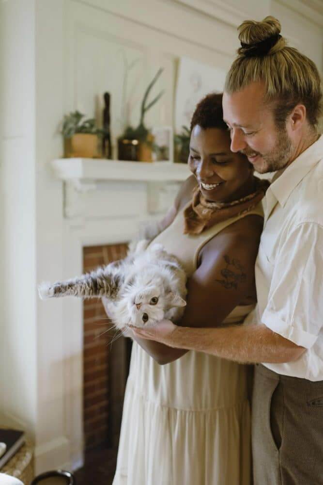 Couple holding a cat representing the pet-friendly apartments charleston sc chewy-dr6wpyr2drc-unsplash-1