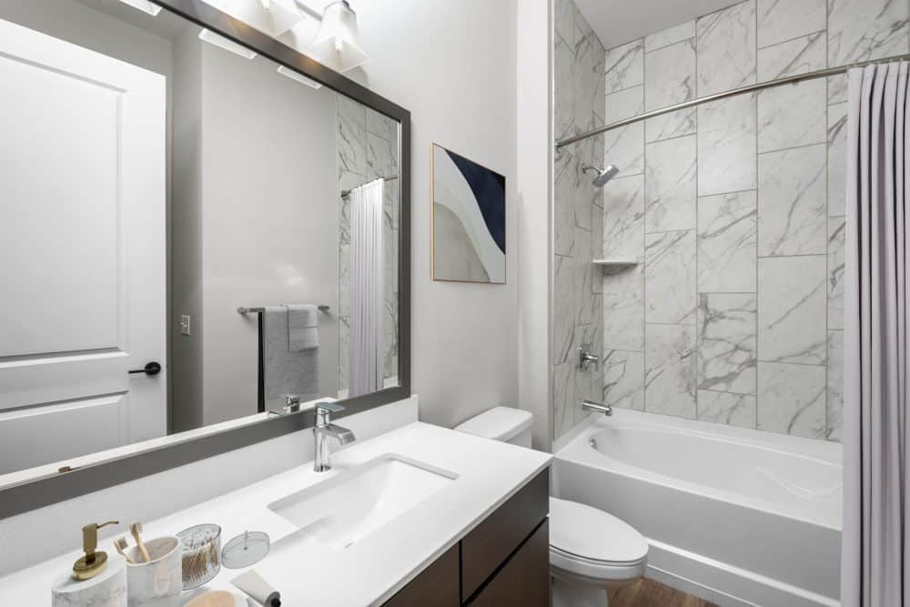 virtually staged apartment bathroom with tub and waterfall shower head