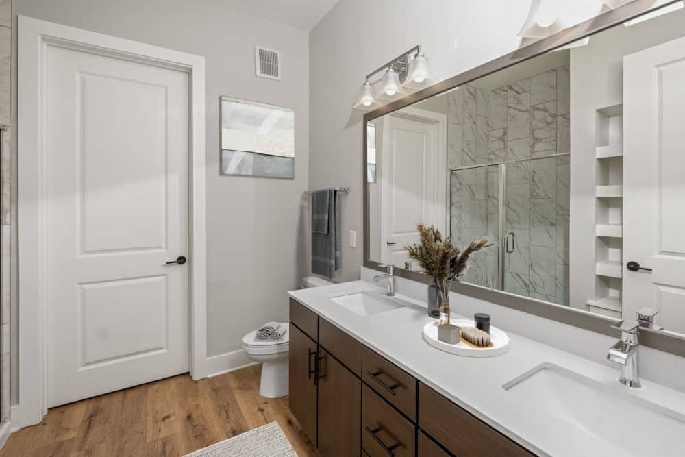 virtually staged apartment bathroom with dual sink vanity