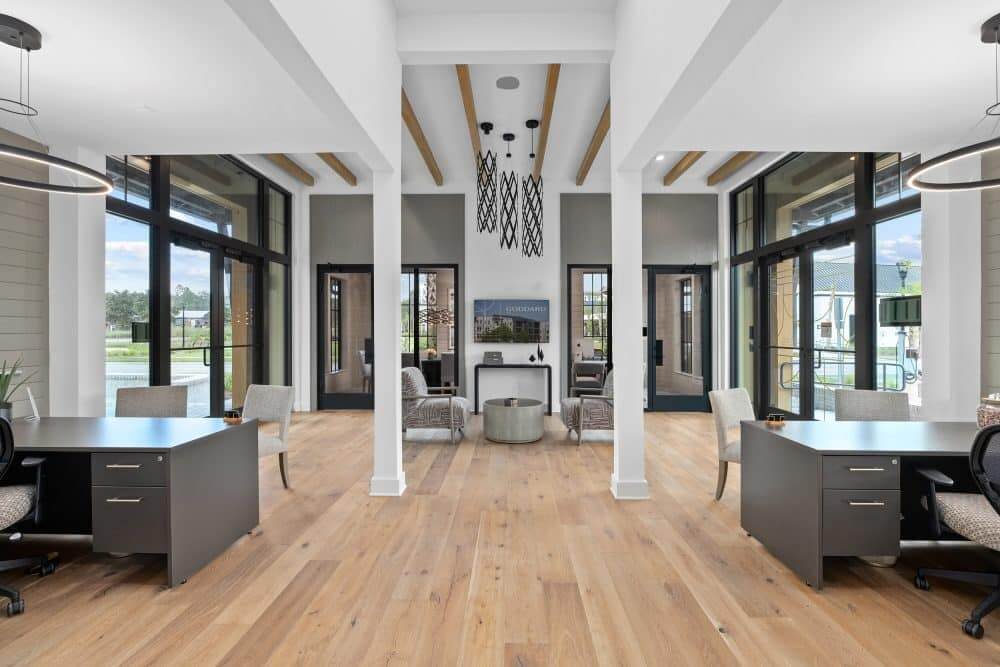 The interior of our leasing office of our community, featuring desks and flat screen TV.