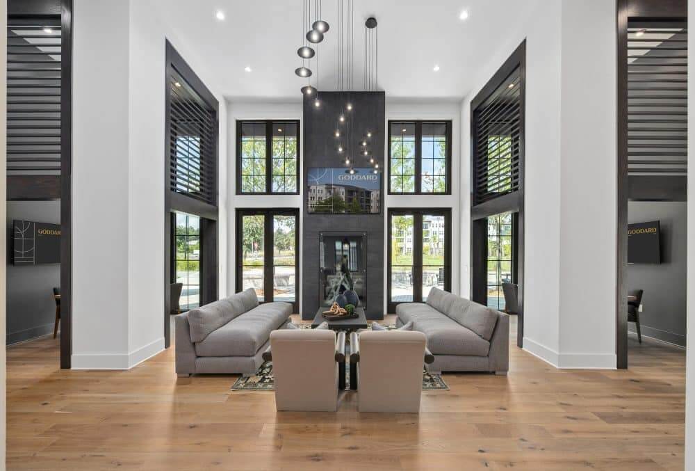 business center lounge and lobby at our apartments for rent in Charleston, SC, featuring wood grain flooring and seating area with fireplace