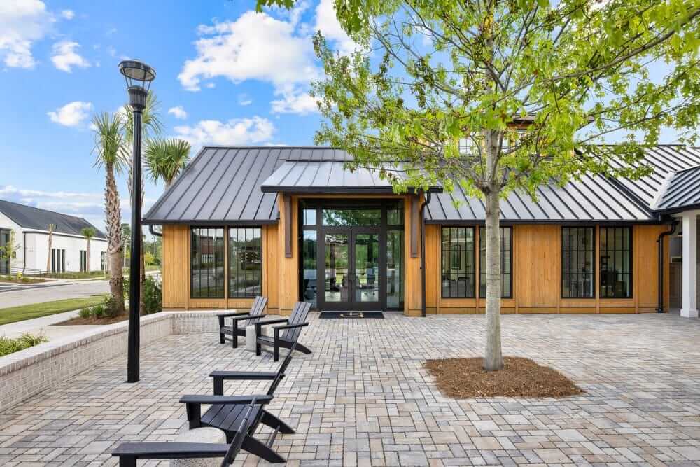 The outdoor lounge at our apartments for rent in Charleston, SC, featuring outdoor furniture and a pool.