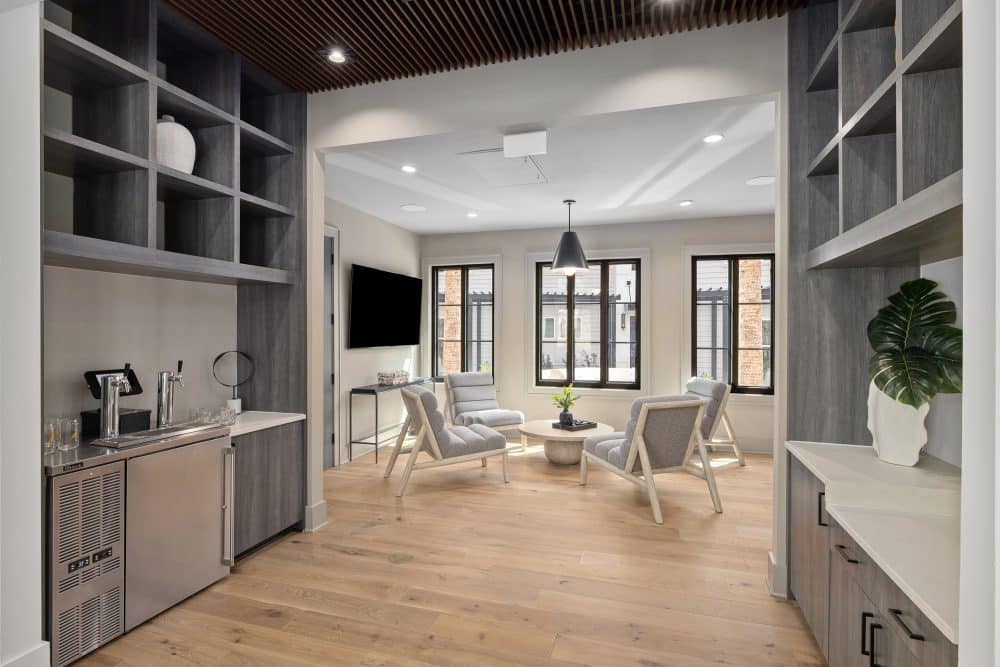 business center lounge and lobby at our apartments for rent in Charleston, SC,featuring wood grain flooring and a flat screen TV.