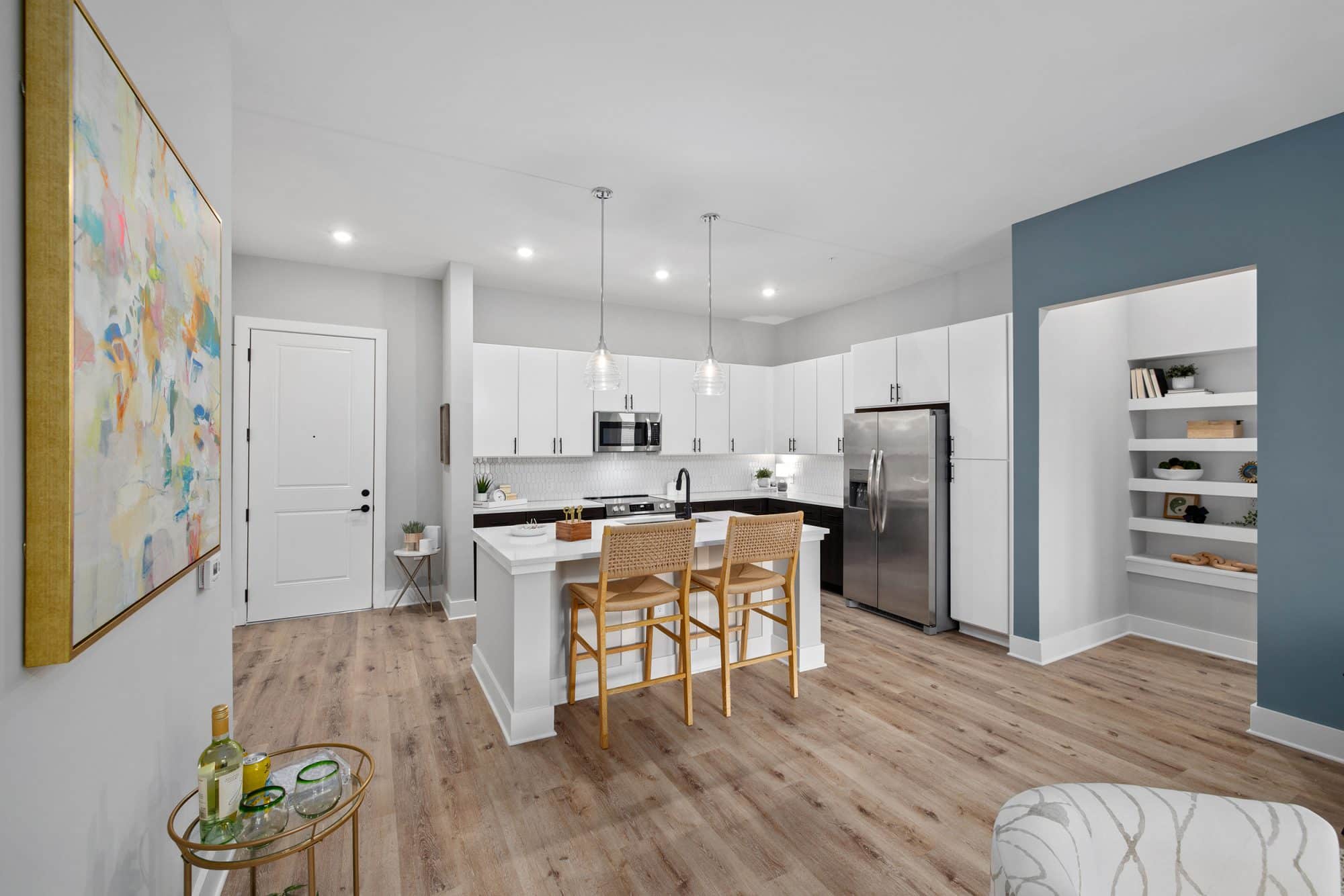 Model kitchen at our apartments for rent in Charleston, SC, featuring two-toned cabinets and stainless steel appliances.