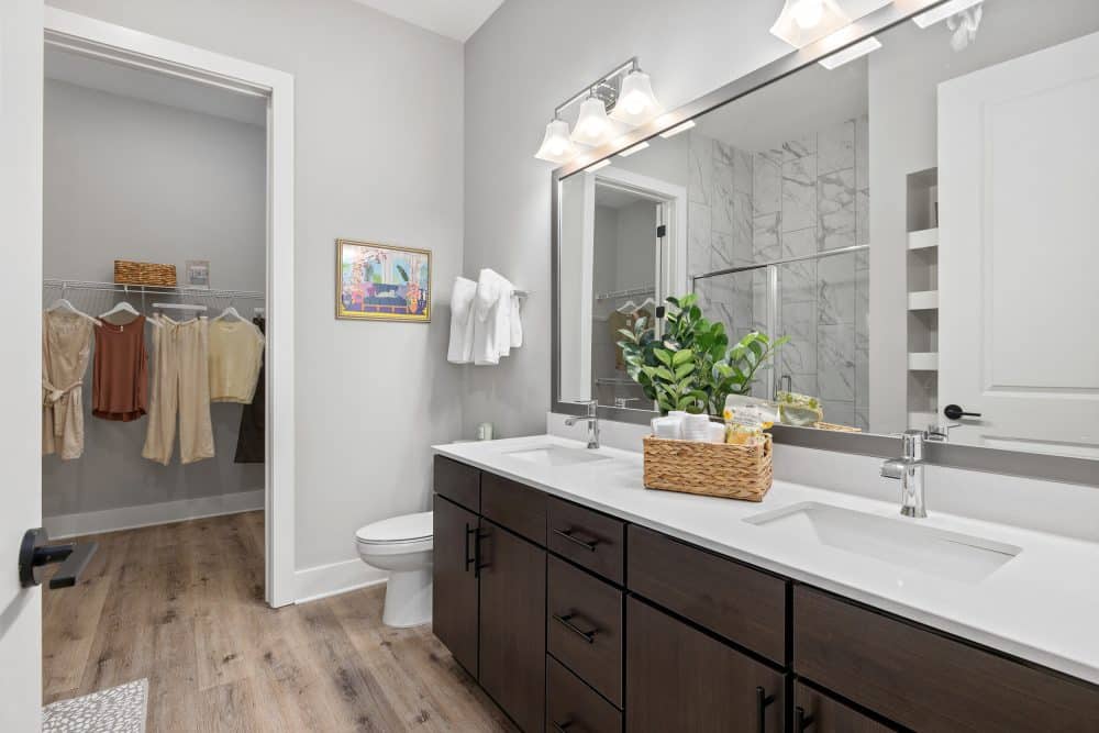 Luxury bathroom at Goddard Point Hope with dual vanity, walk-in closet, and contemporary finishes