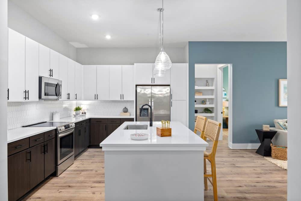 Model kitchen at our apartments for rent in Charleston, SC, featuring two-toned cabinets and stainless steel appliances.